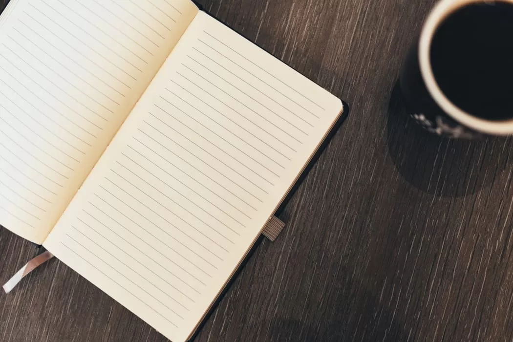 blank journal and coffee mug